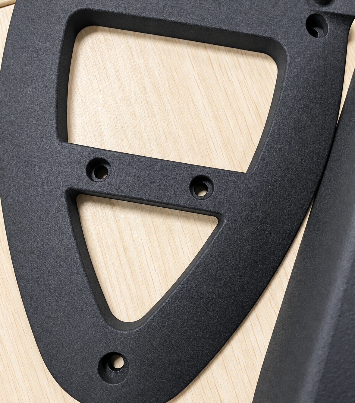 Close detail of a black nylon 3D printed functional plate